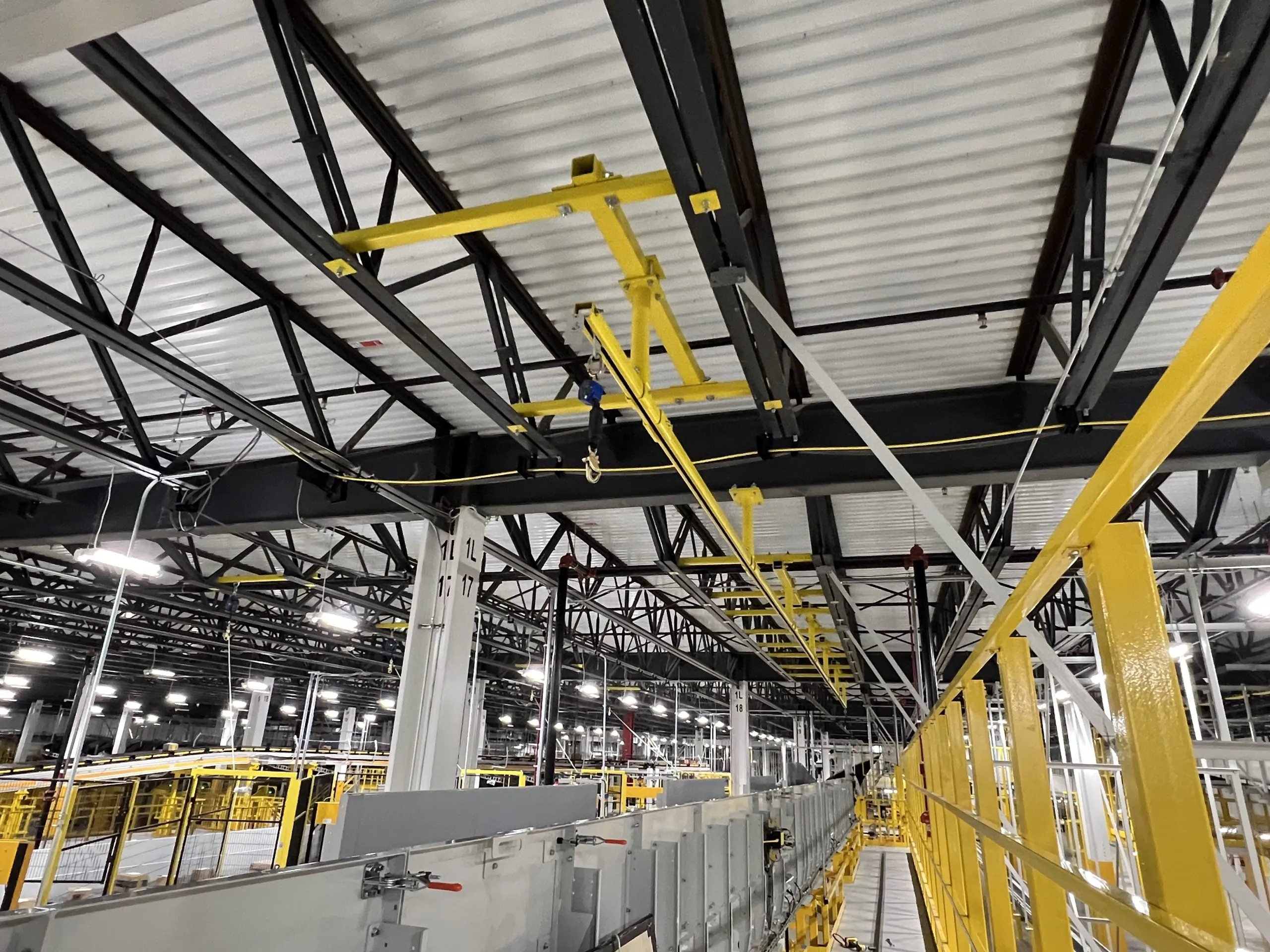 Overhead horizontal lifeline system installed in distribution center for worker safety