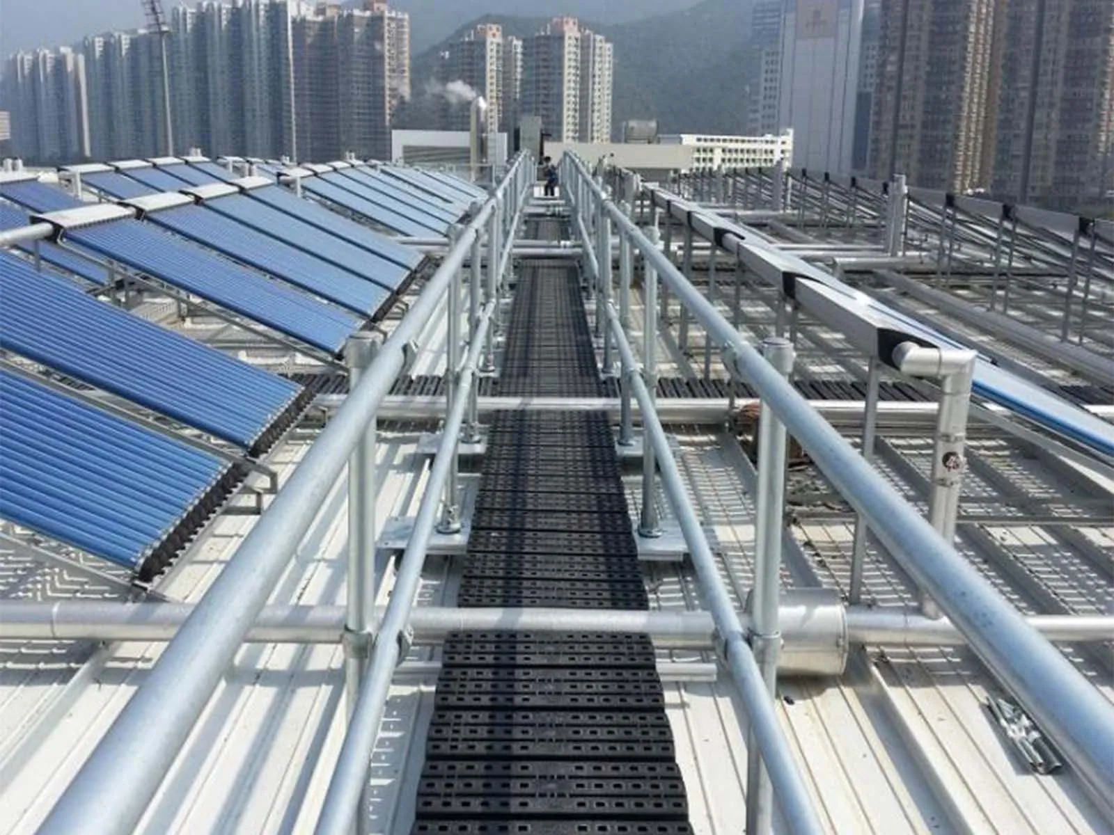 Elevated catwalk system with guardrails for safe access in industrial facility
