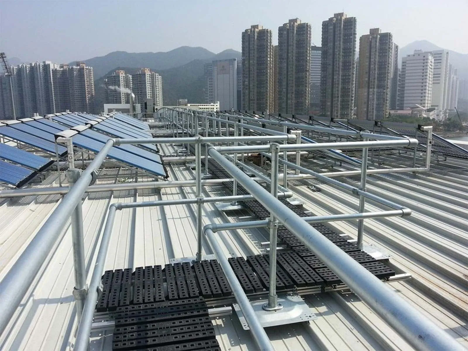 Elevated catwalk system with guardrails for safe access in industrial facility