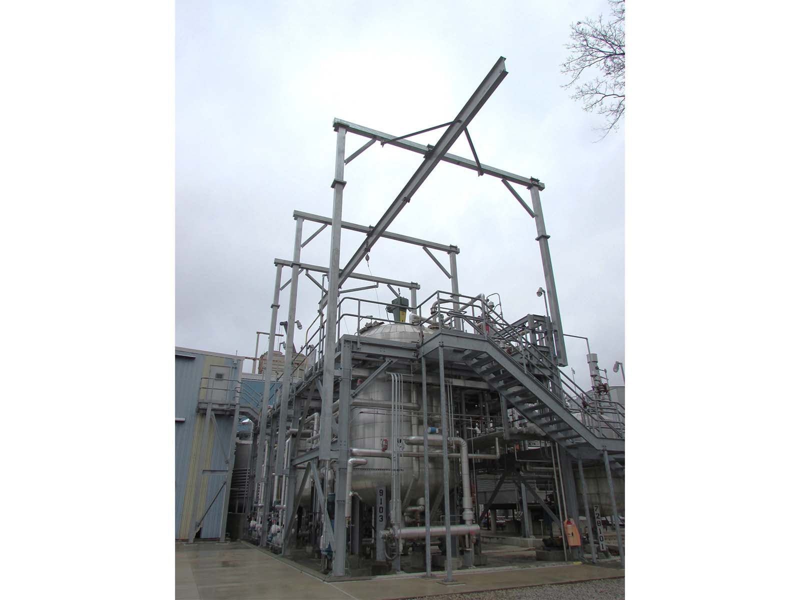 Engineered fall arrest solution providing overhead protection for storage tank maintenance