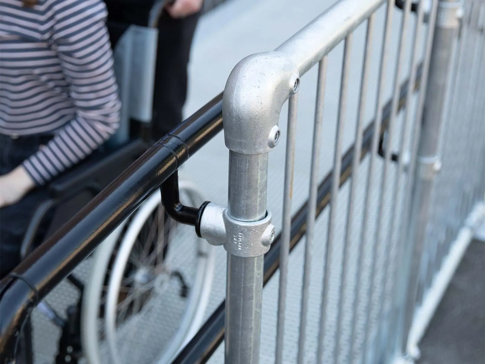ADA-compliant rooftop guardrail providing passive fall protection at school or university
