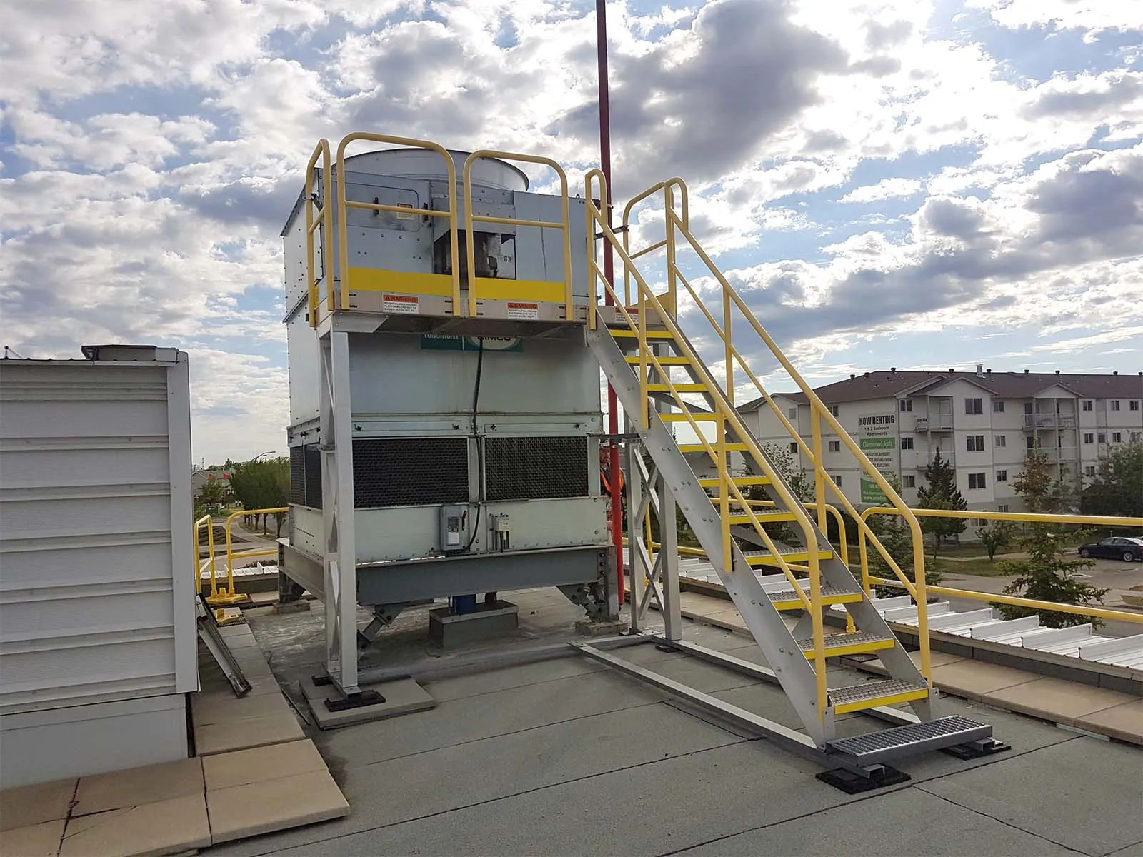 Technician using lifeline system while accessing rooftop equipment for maintenance