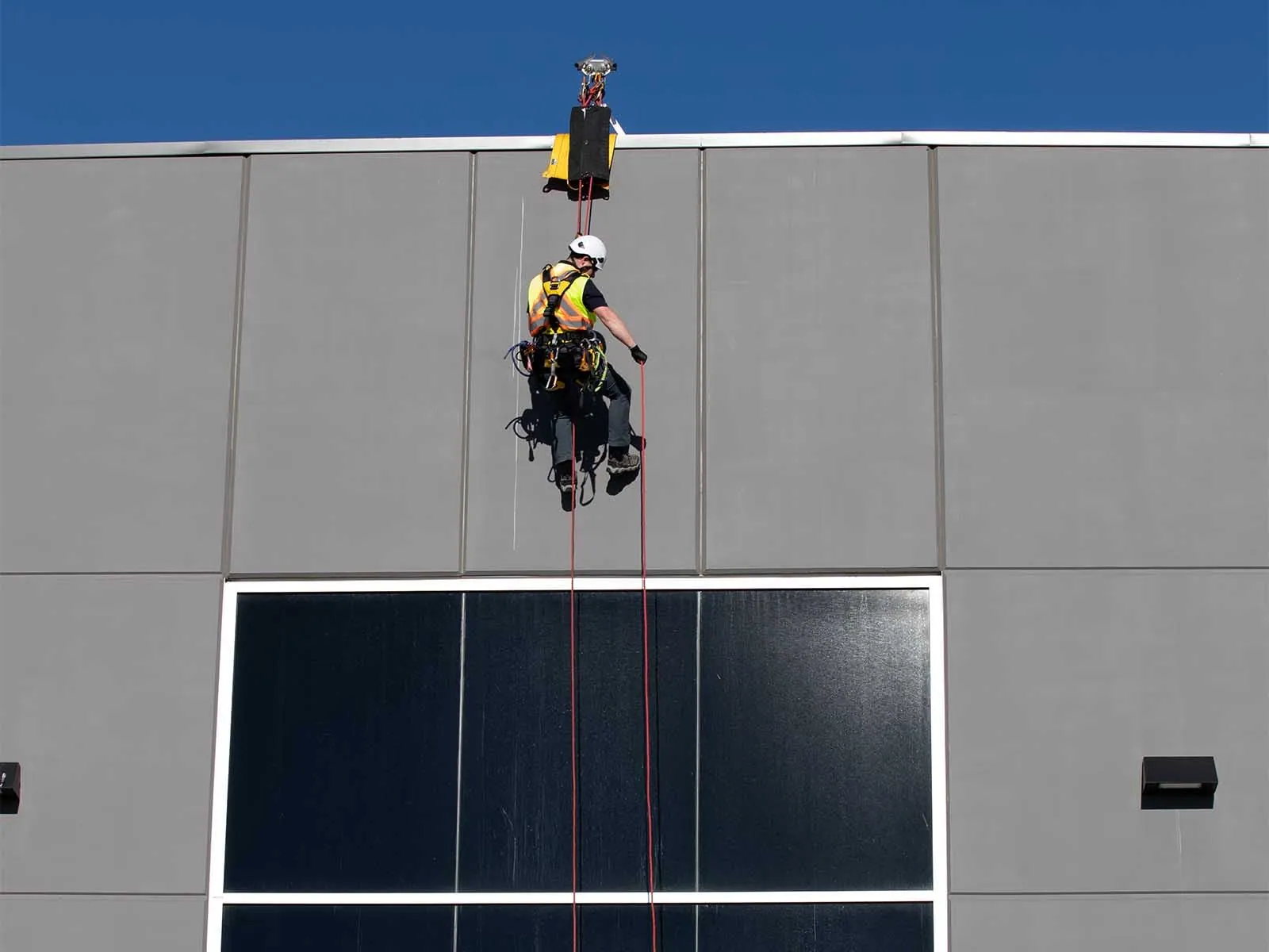 Fall protection system installed for safe access to building facade during maintenance