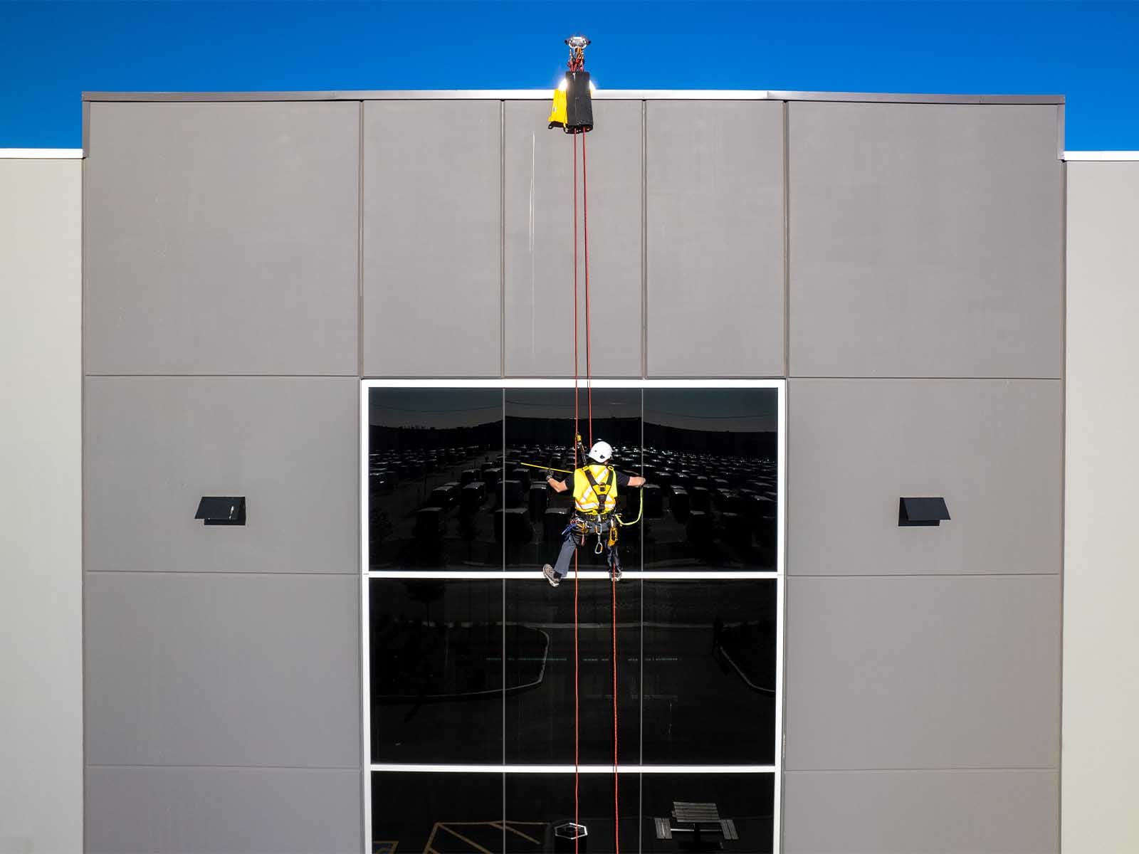 Fall protection system installed for safe access to building facade during maintenance
