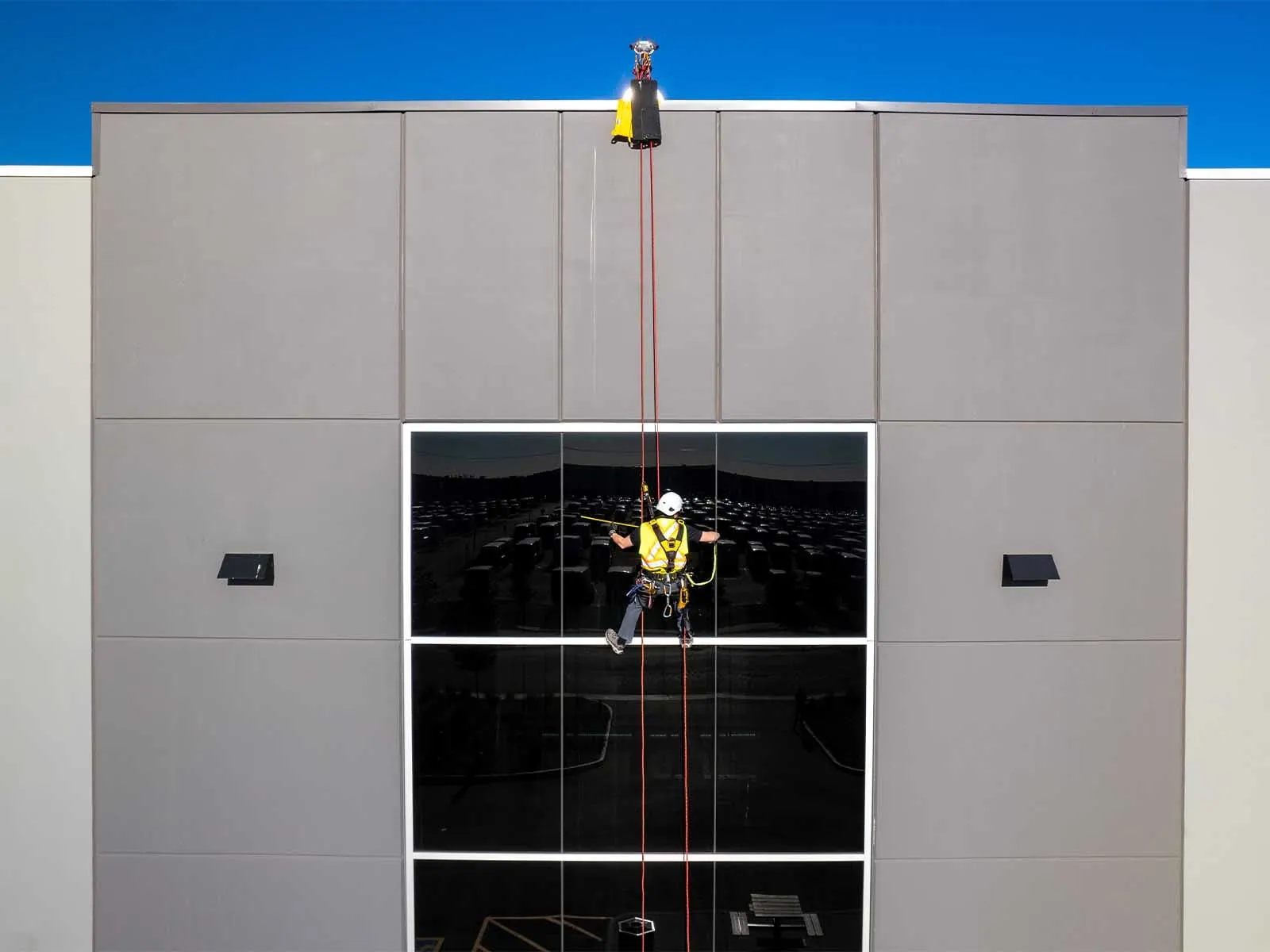 Fall protection system installed for safe access to building facade during maintenance