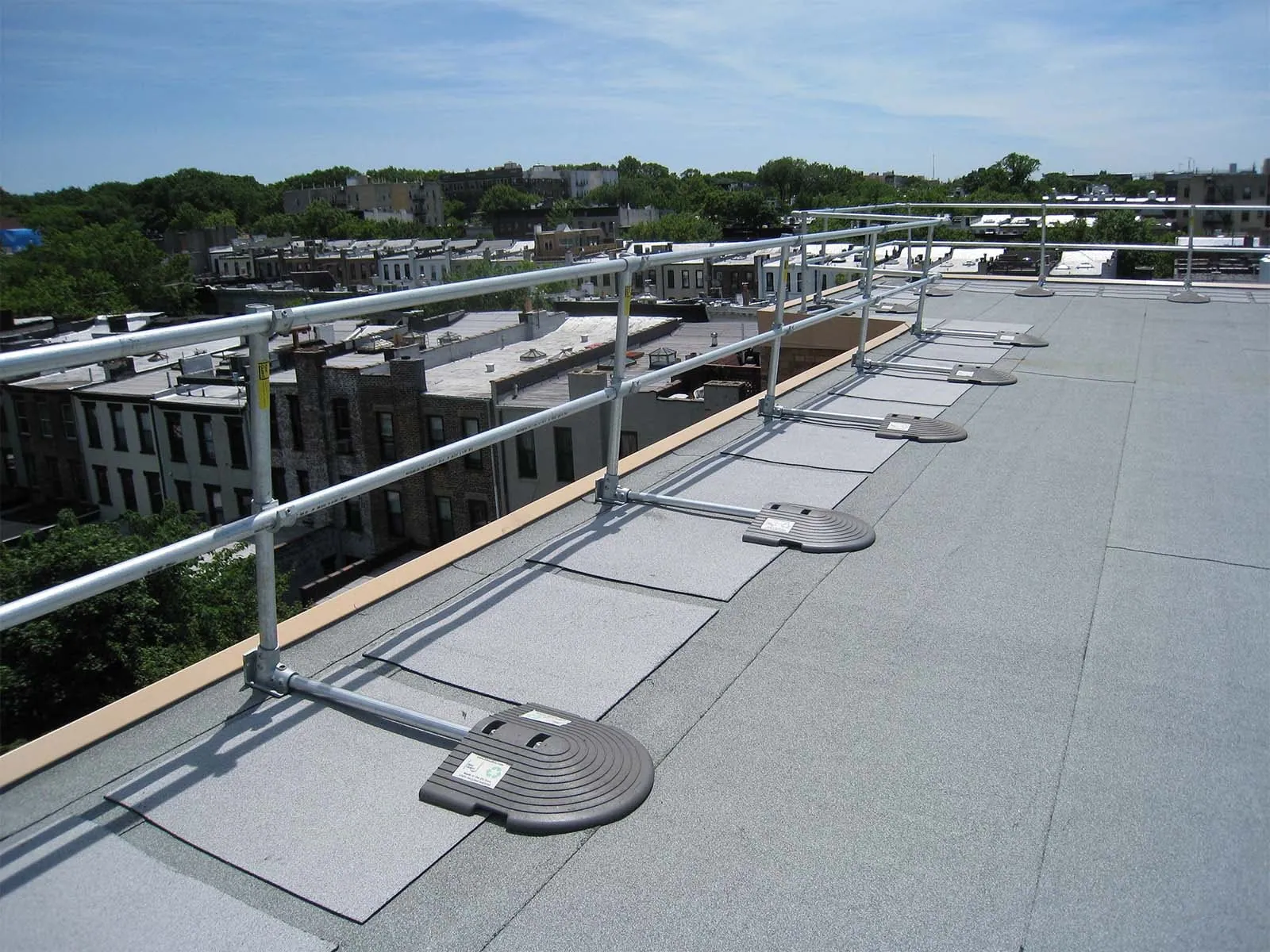 Freestanding roof guardrail system installed on flat commercial rooftop for fall protection