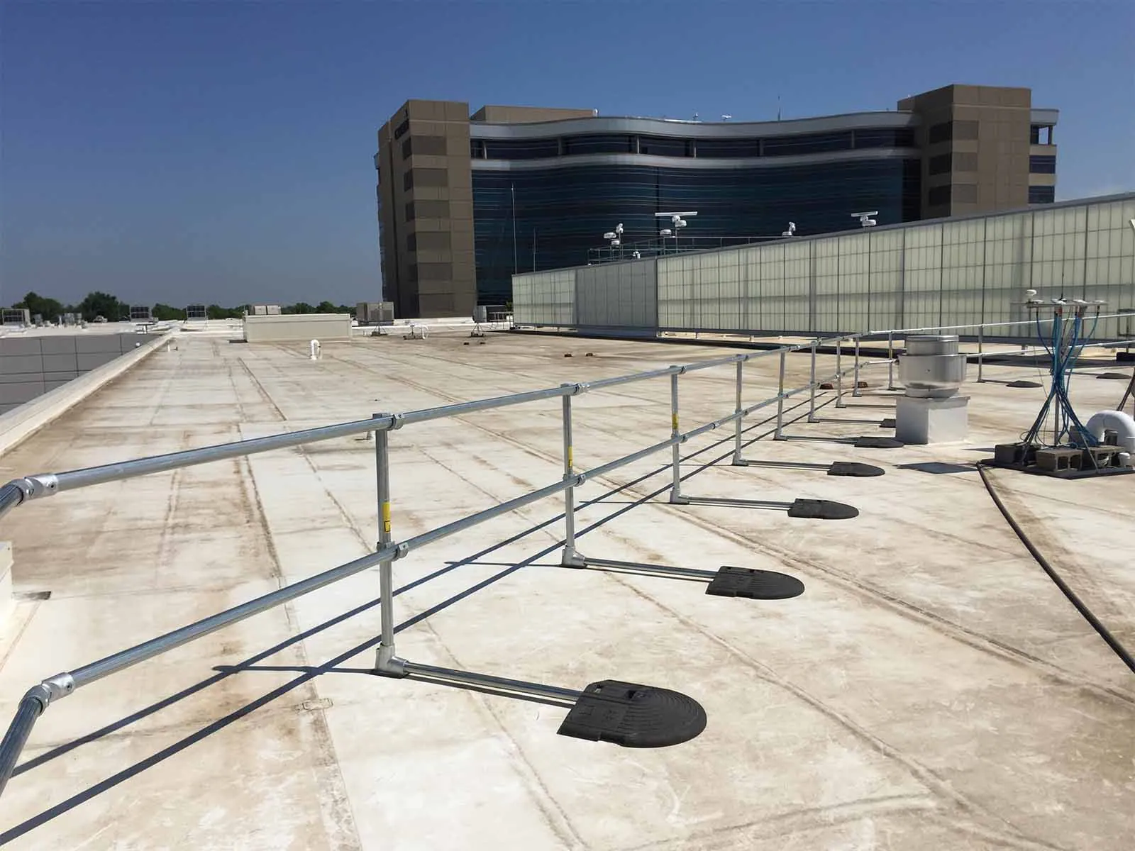 Freestanding roof guardrail system installed on flat commercial rooftop for fall protection