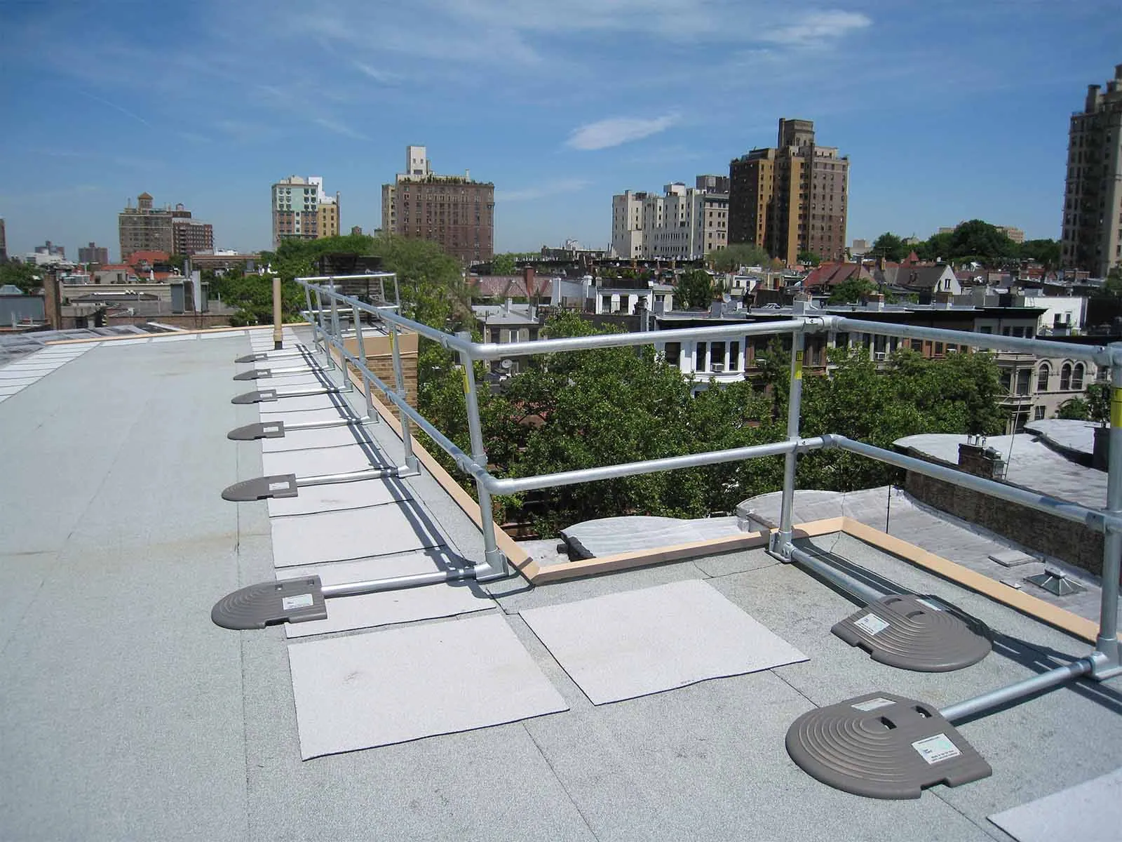 Freestanding roof guardrail system installed on flat commercial rooftop for fall protection