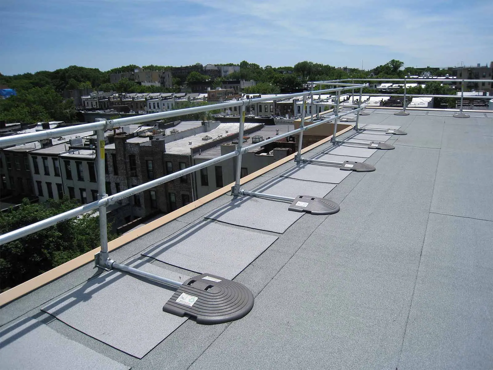 Freestanding roof guardrail system installed on flat commercial rooftop for fall protection