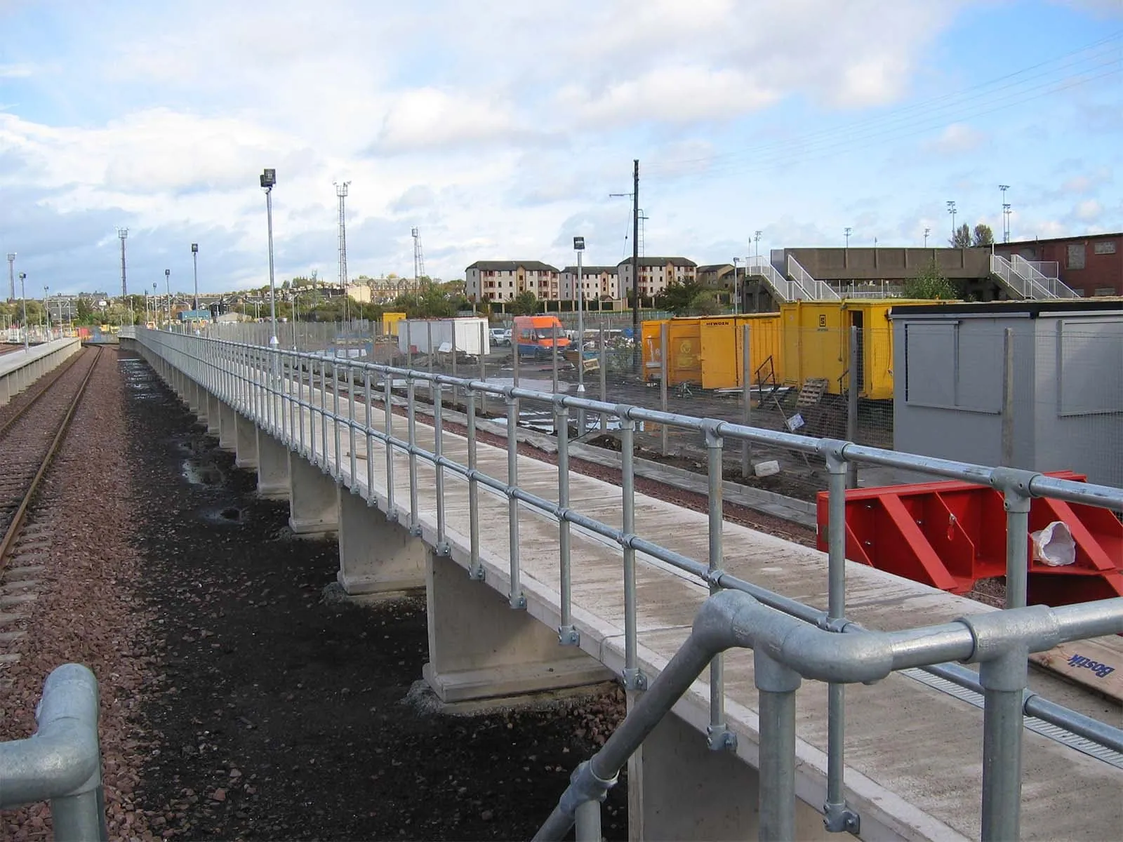 Ground-based guardrail system installed to provide fall protection at elevated work areas