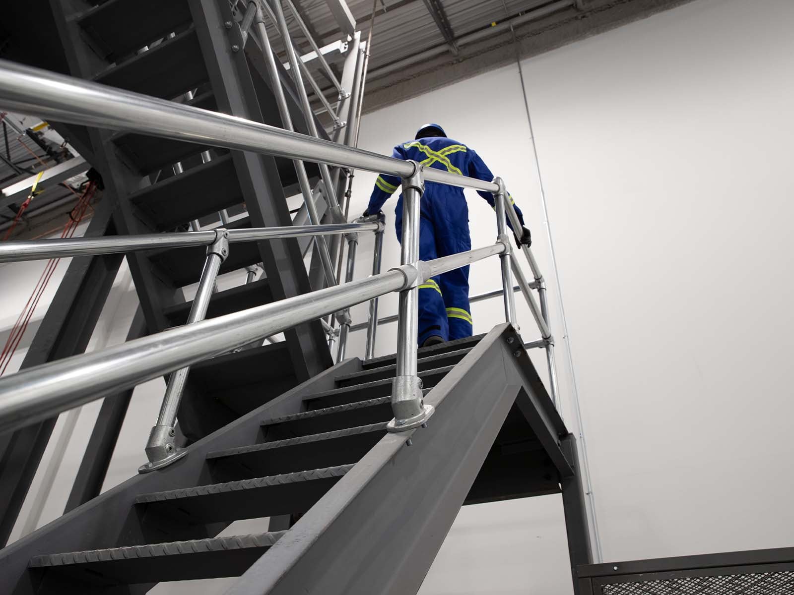 Ground-based guardrail system installed to provide fall protection at elevated work areas