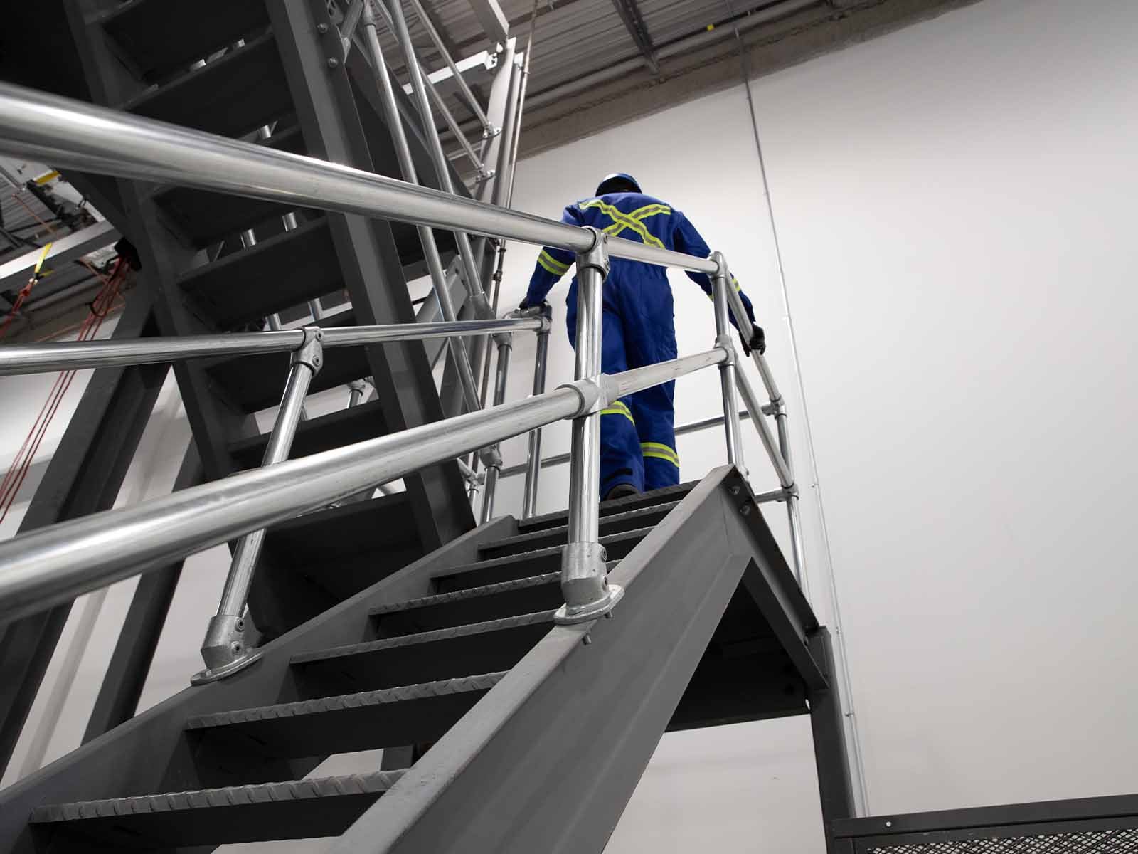 Ground-based guardrail system installed to provide fall protection at elevated work areas