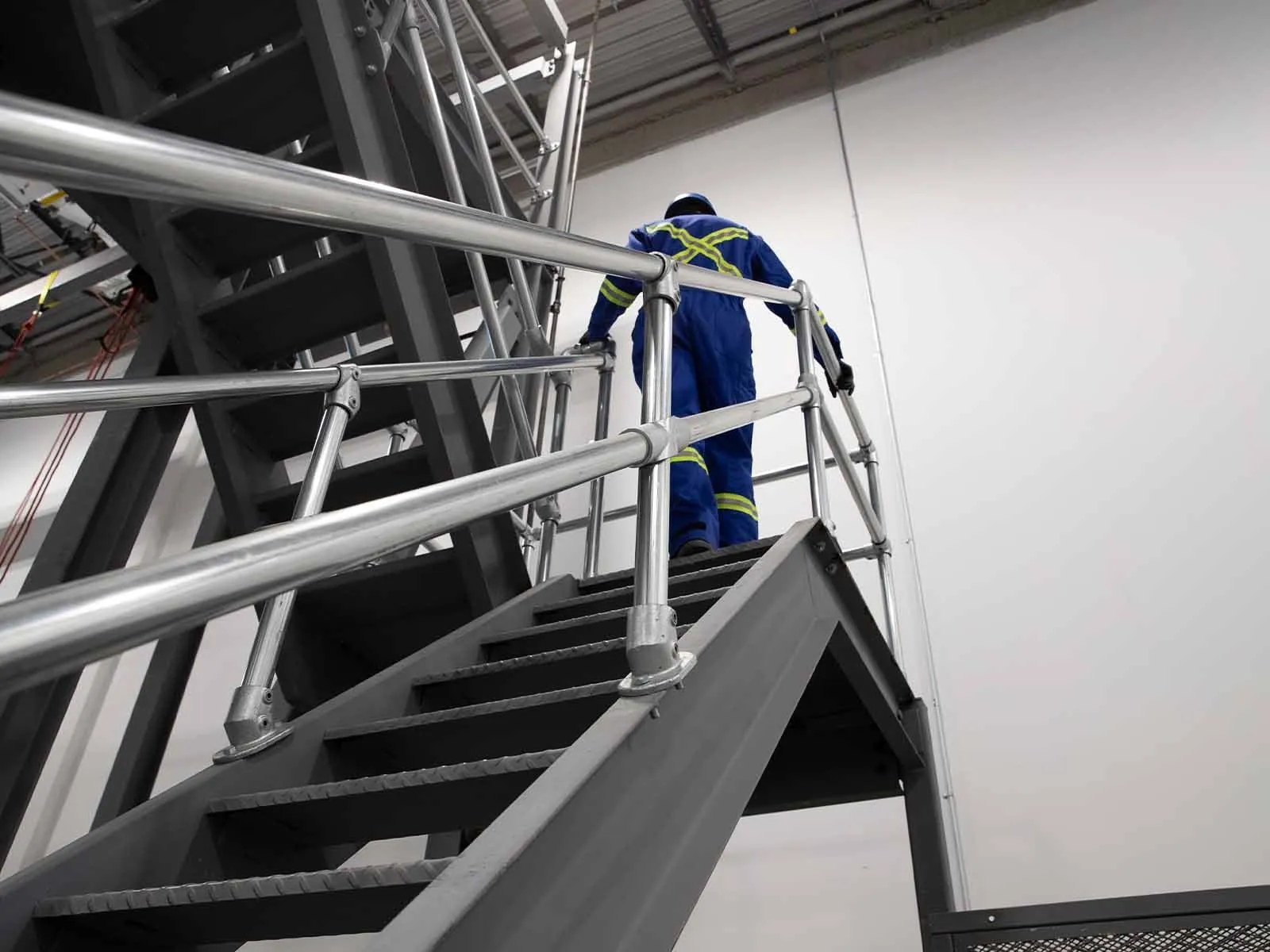 Ground-based guardrail system installed to provide fall protection at elevated work areas