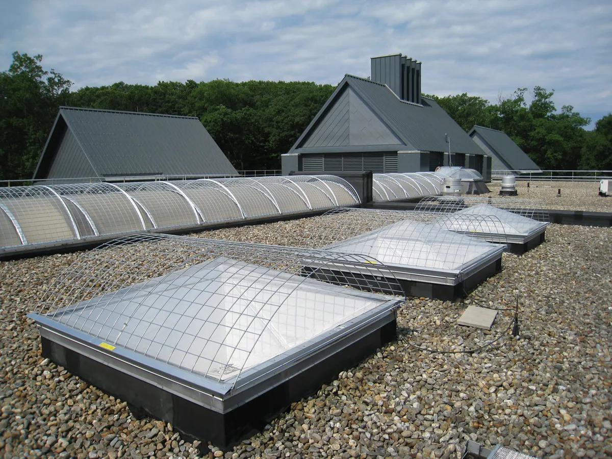 Durable steel skylight cover mounted over rooftop opening for safety compliance
