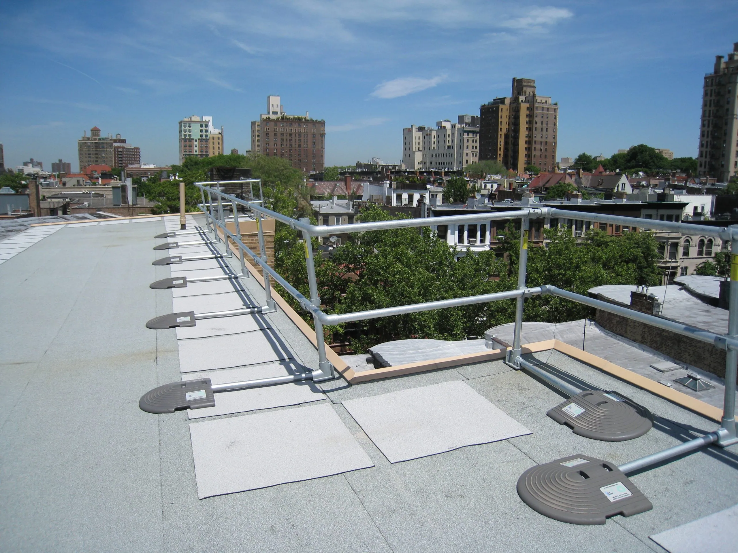 Freestanding roof guardrail system installed for passive fall protection