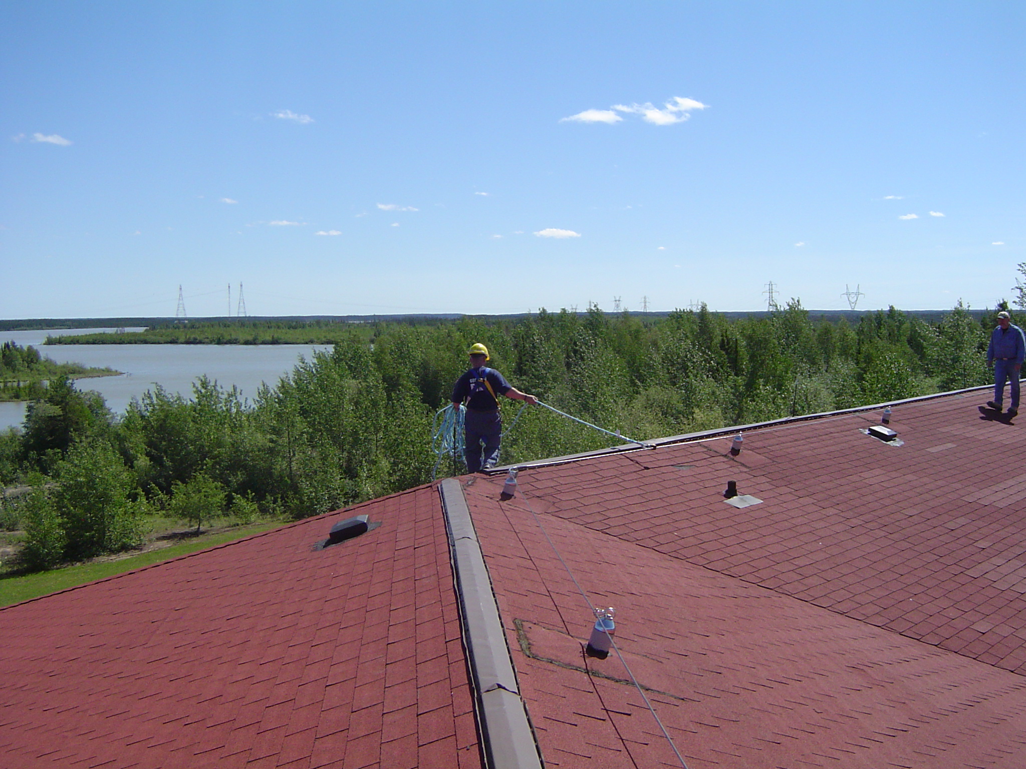 Horizontal lifeline system with engineered anchor points providing continuous roof fall protection
