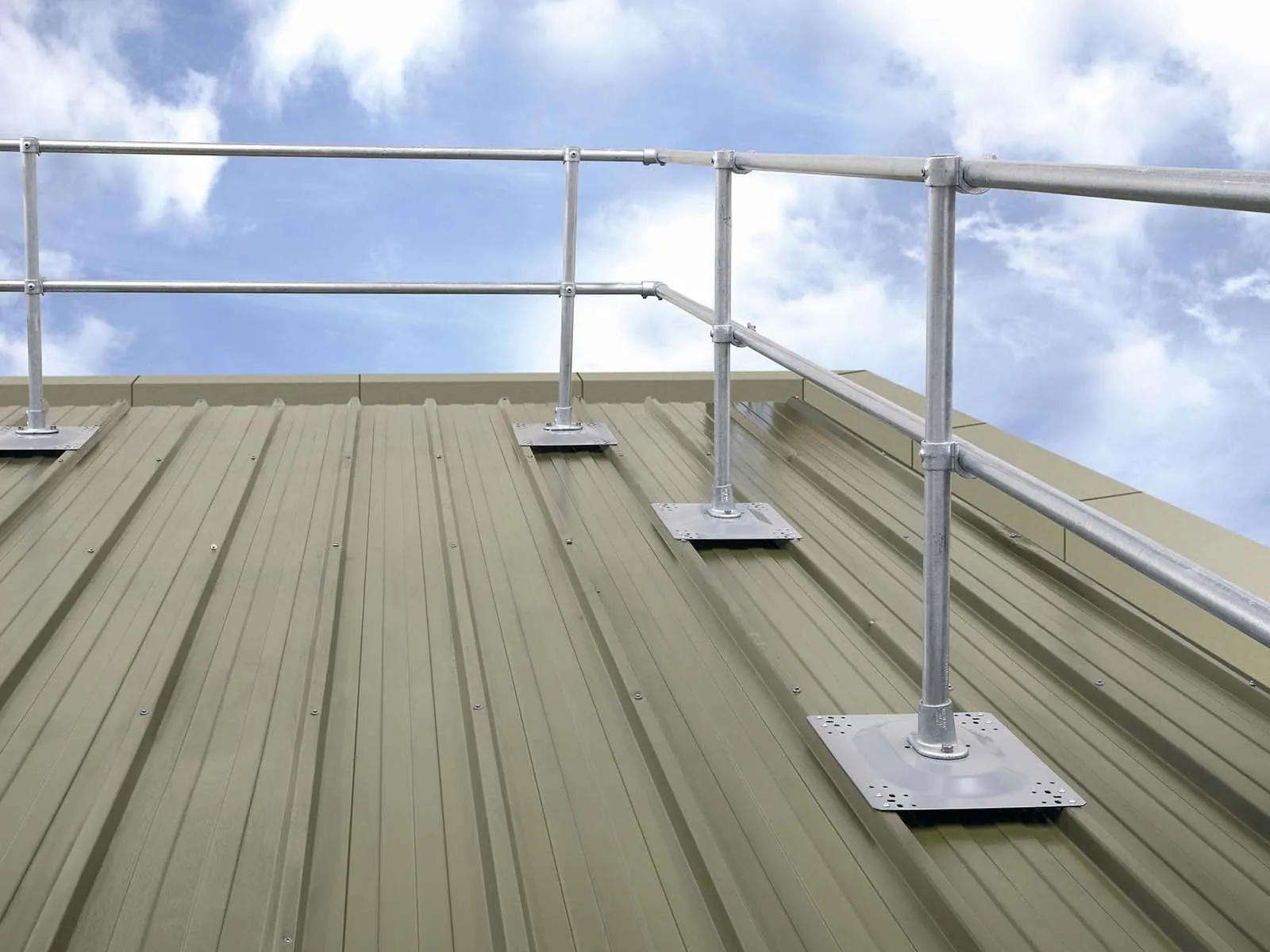 Guardrail system installed on metal roof for fall hazard prevention