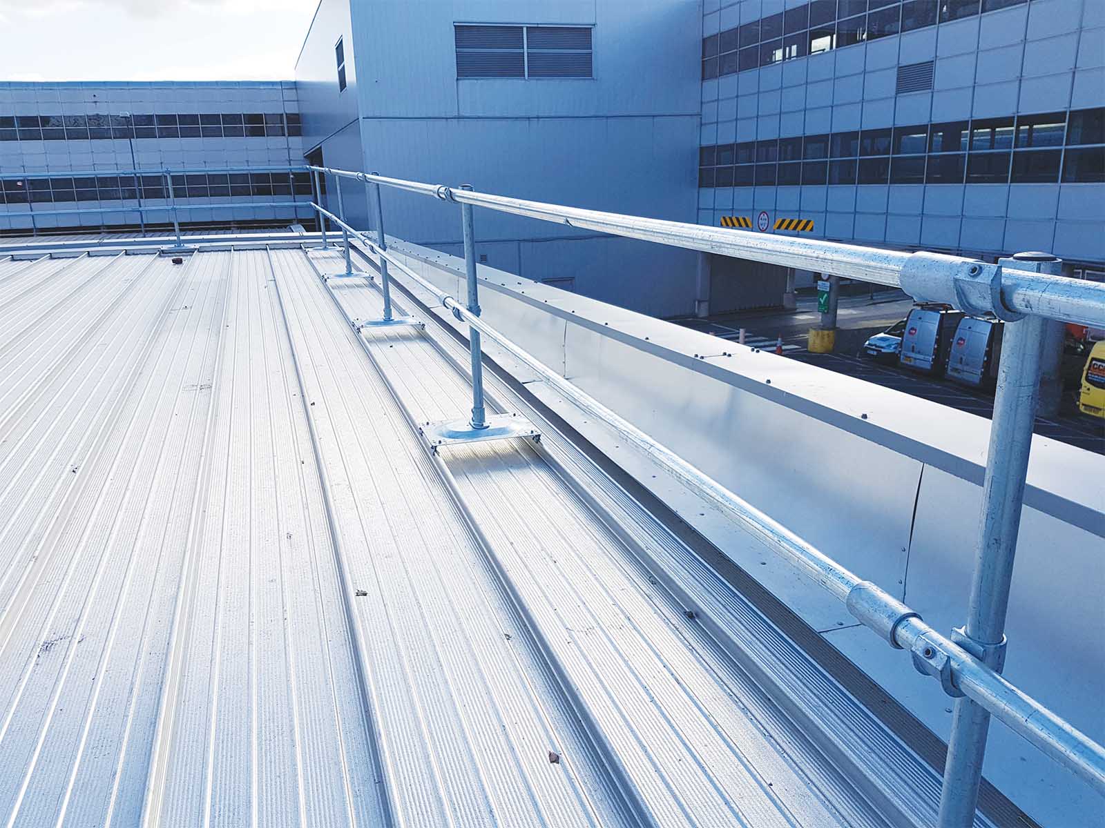 Guardrail system installed on metal roof for fall hazard prevention