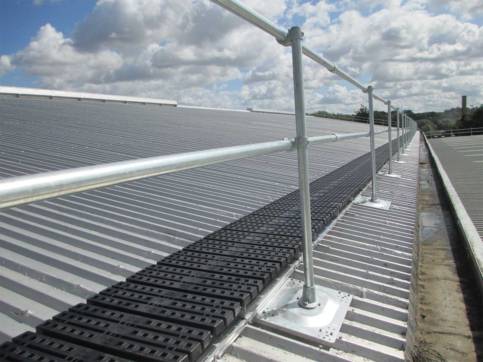 Guardrail system installed on metal roof for fall hazard prevention