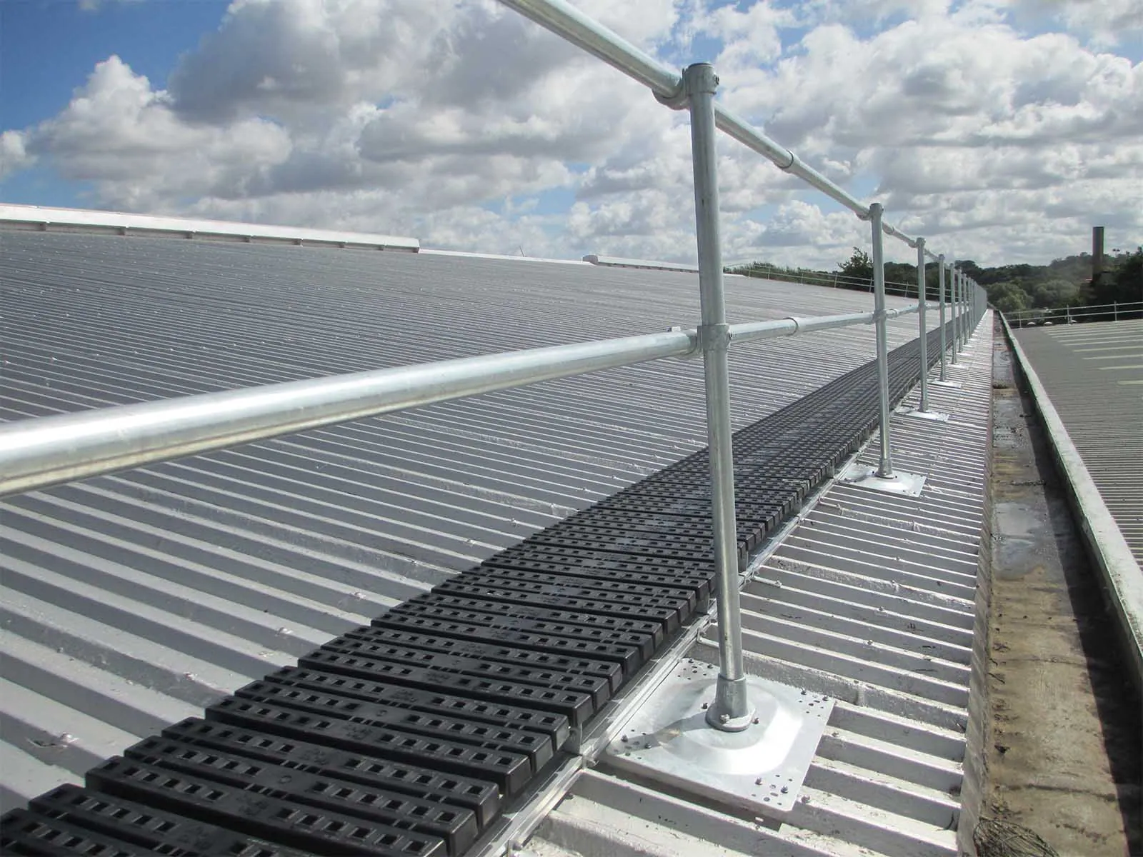 Guardrail system installed on metal roof for fall hazard prevention