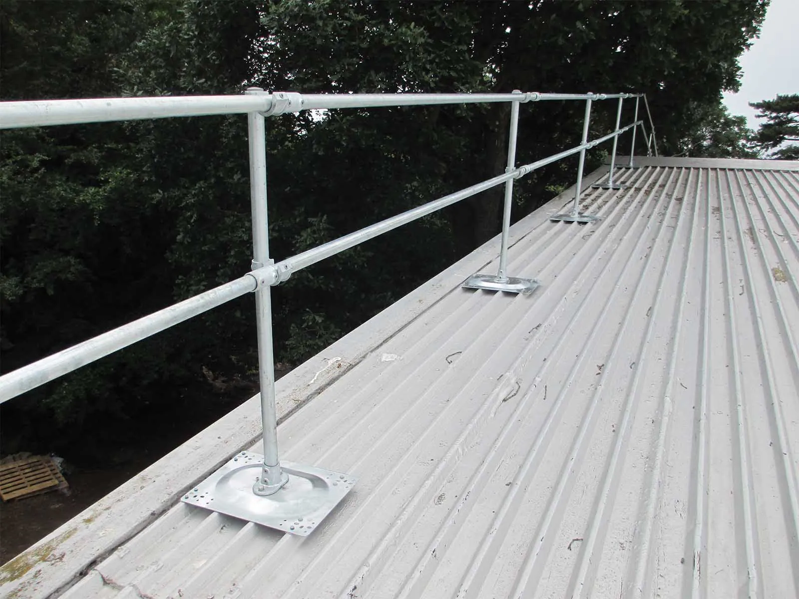 Guardrail system installed on metal roof for fall hazard prevention