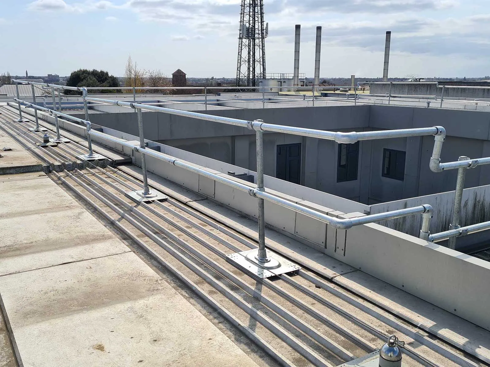 Guardrail system installed on metal roof for fall hazard prevention