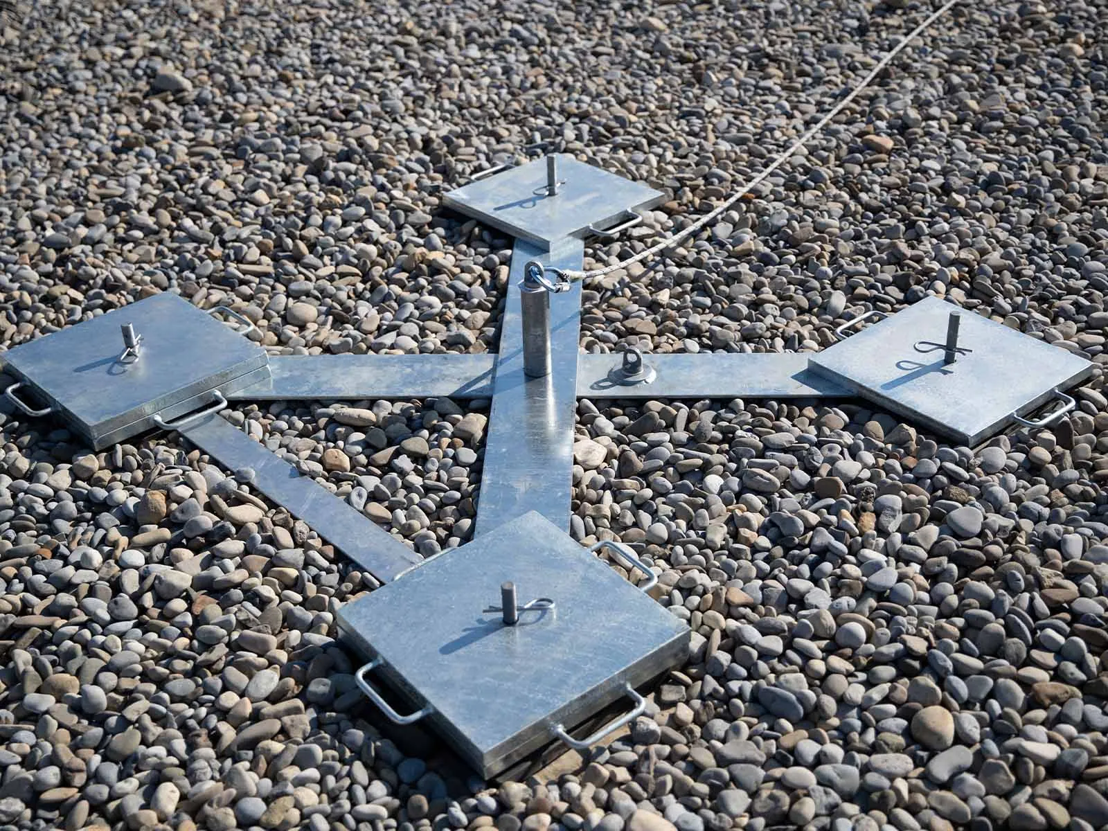 Non-penetrating roof anchor system installed on flat commercial rooftop for fall protection