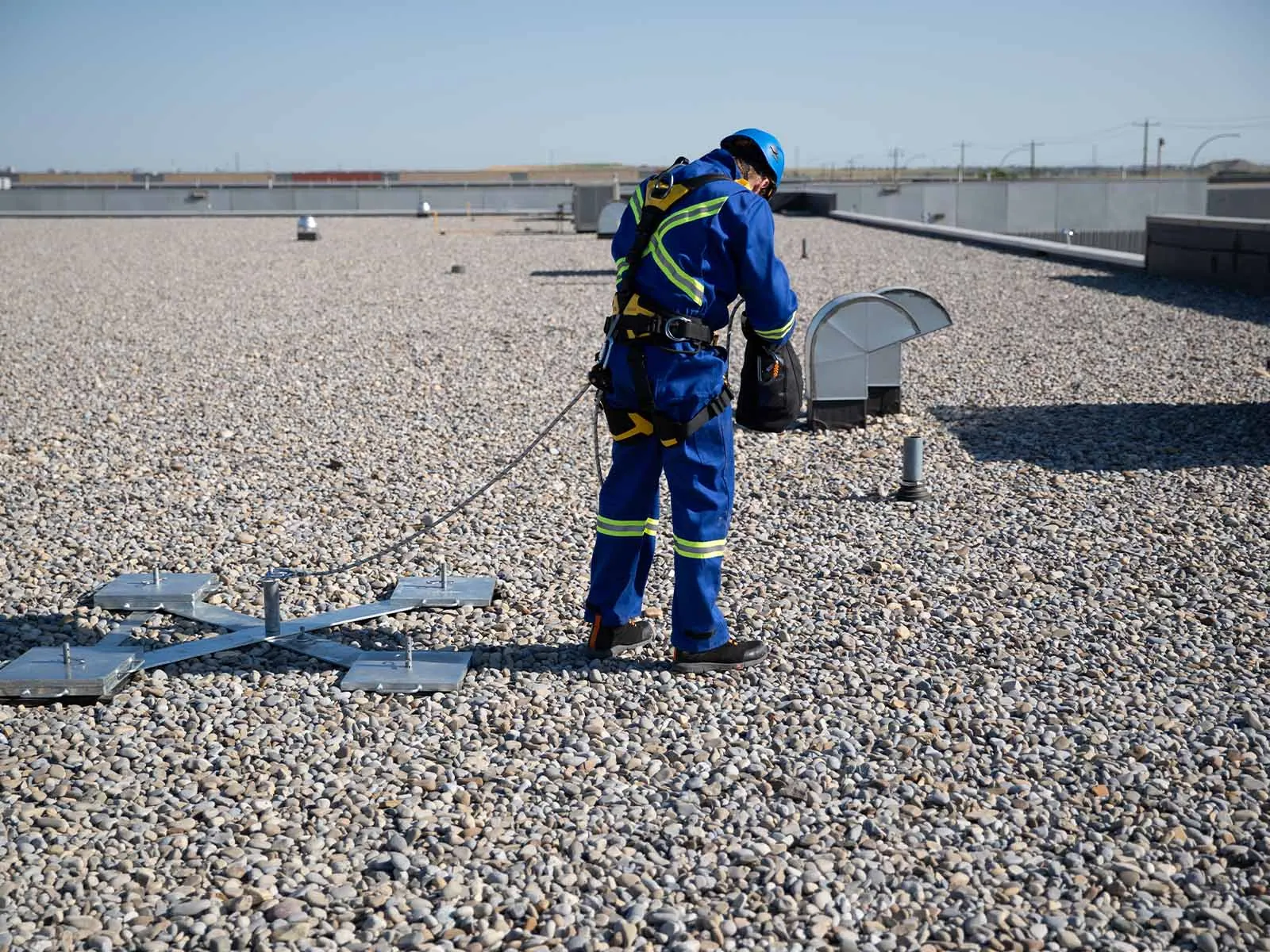 Non-penetrating roof anchor system installed on flat commercial rooftop for fall protection