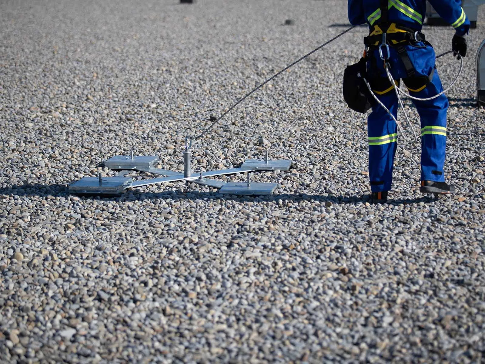 Non-penetrating roof anchor system installed on flat commercial rooftop for fall protection