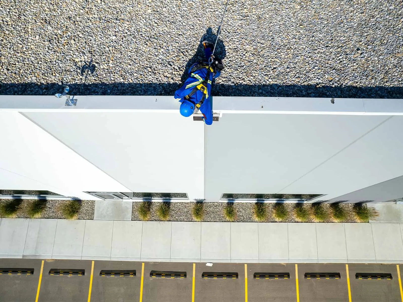Non-penetrating roof anchor system installed on flat commercial rooftop for fall protection