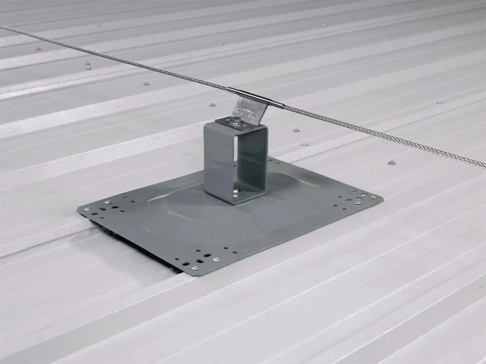 Fall protection system installed on standing seam metal roof for worker safety