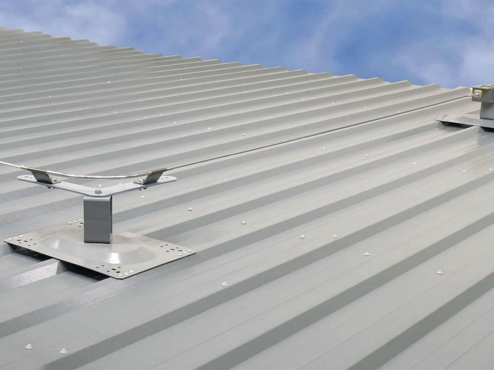 Fall protection system installed on standing seam metal roof for worker safety