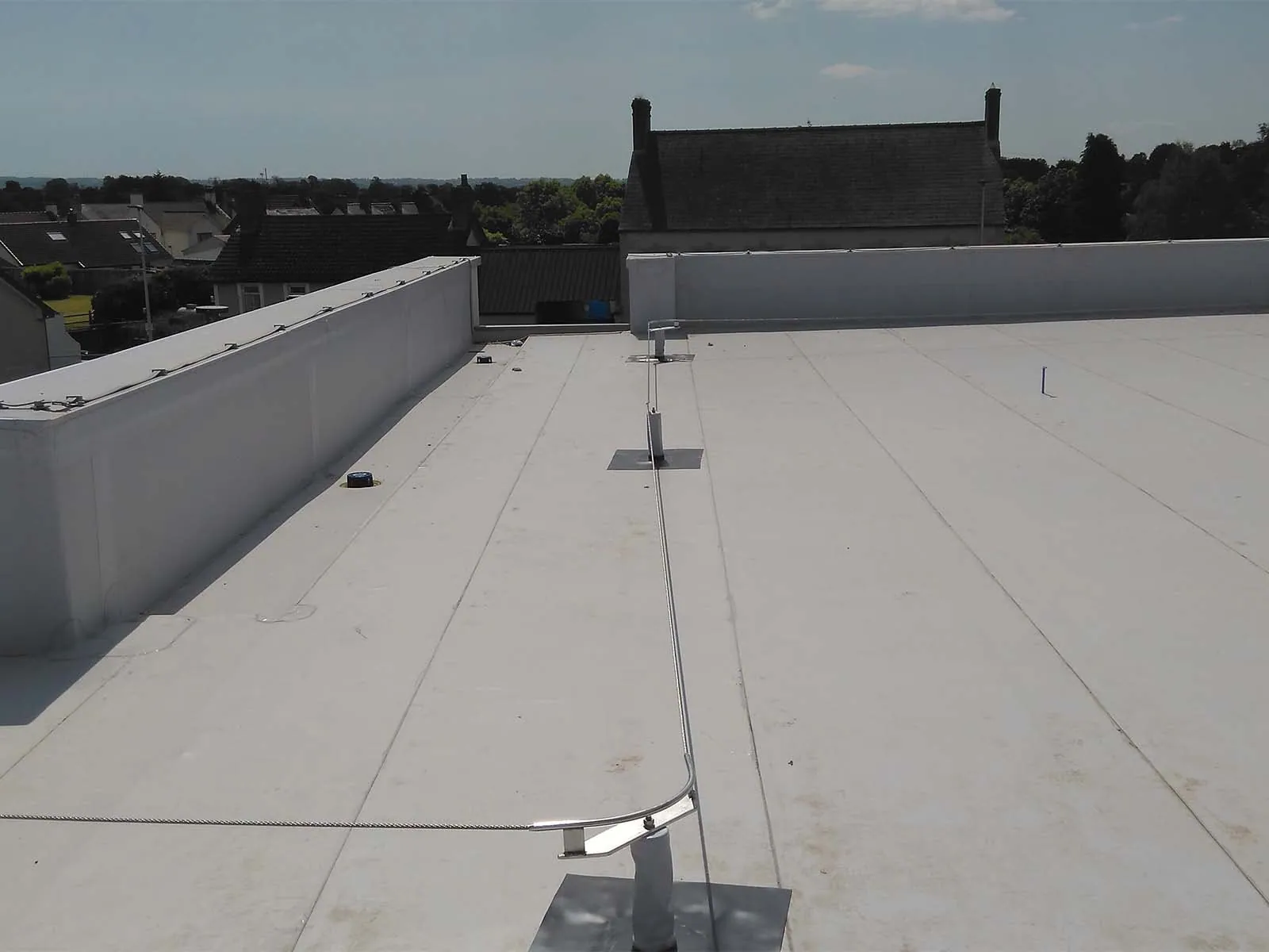 Fall protection system installed on standing seam metal roof for worker safety