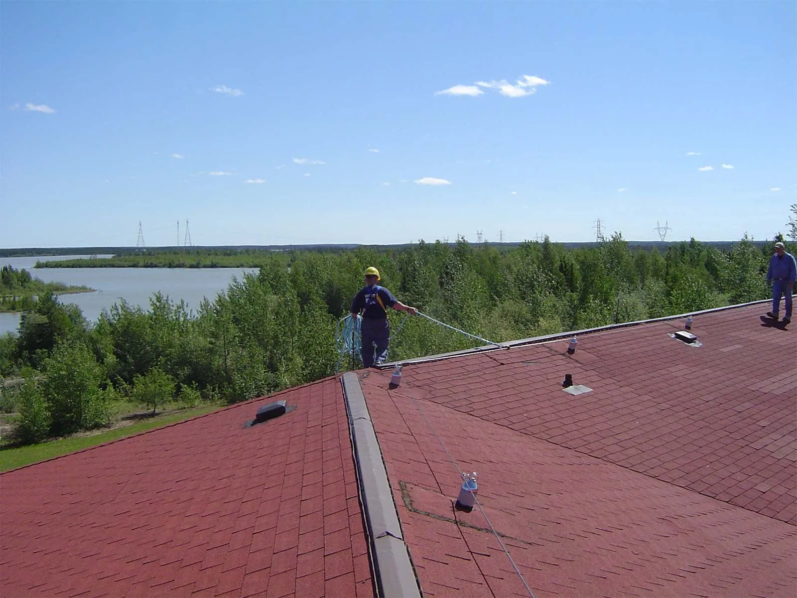 Fall protection system installed on standing seam metal roof for worker safety
