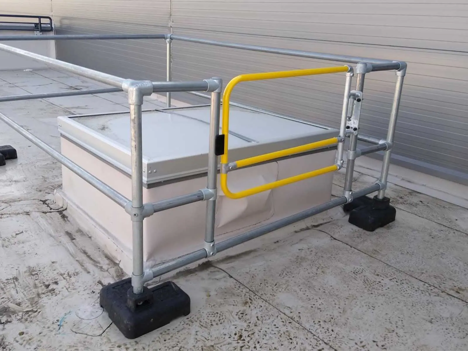 Freestanding skylight guardrail system installed on rooftop for fall hazard prevention
