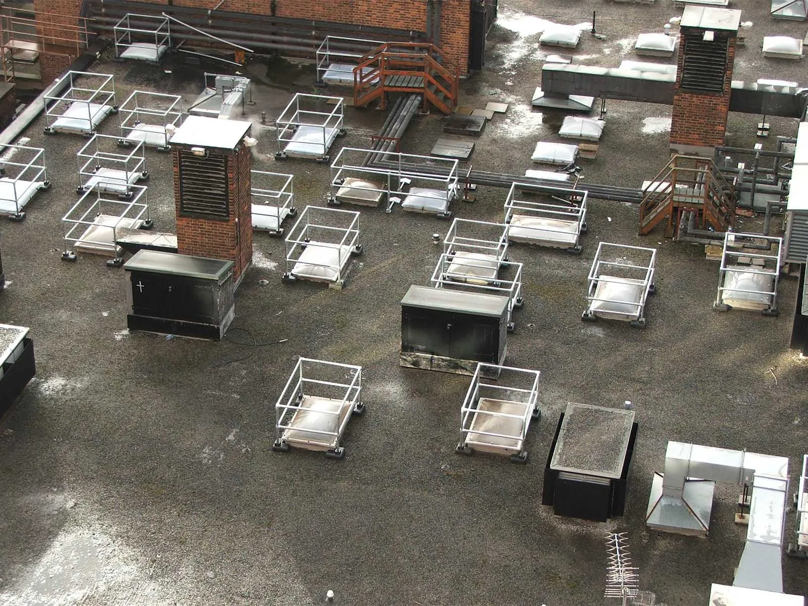 Freestanding skylight guardrail system installed on rooftop for fall hazard prevention