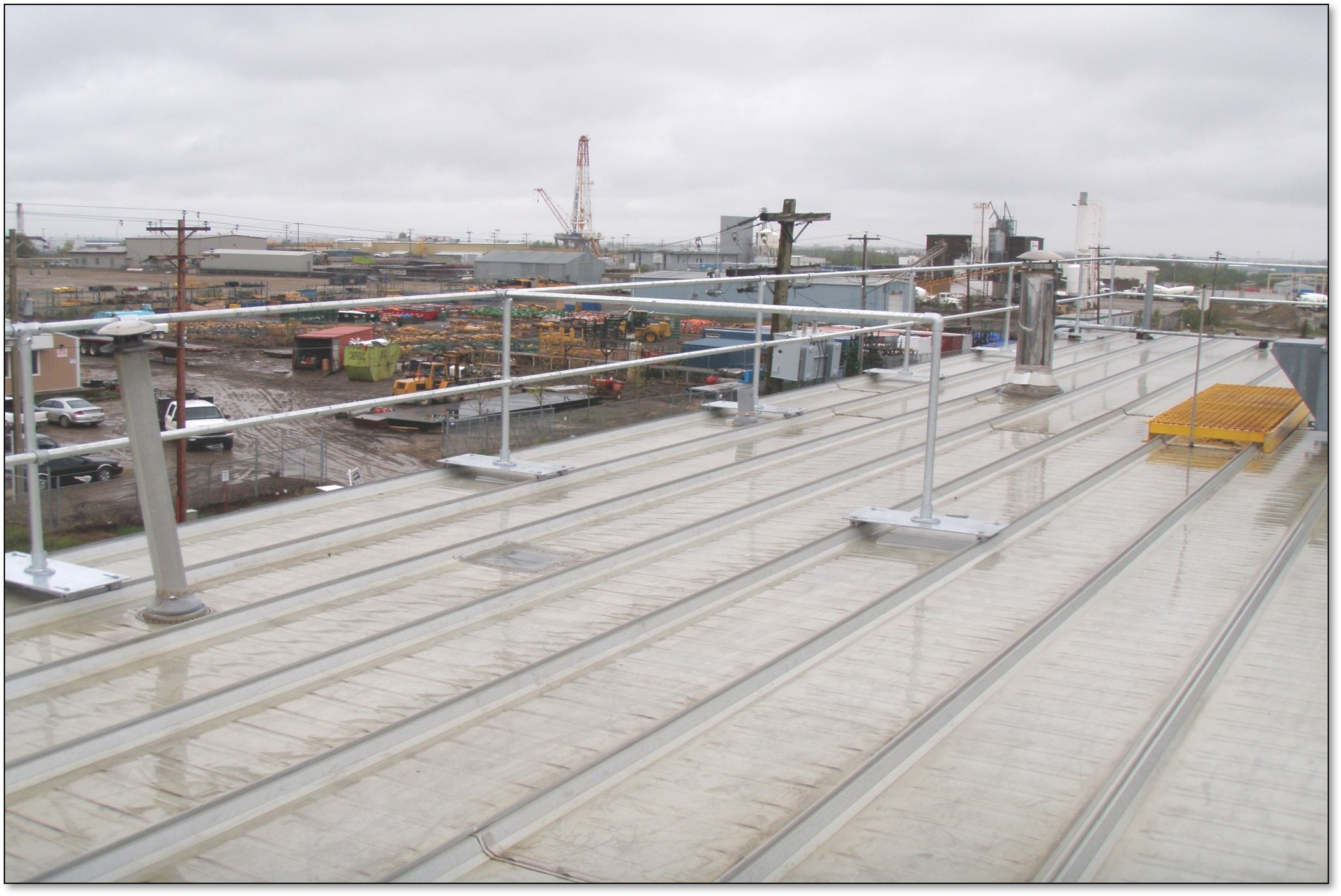 Engineered guardrail system designed for high-wind industrial rooftop environments