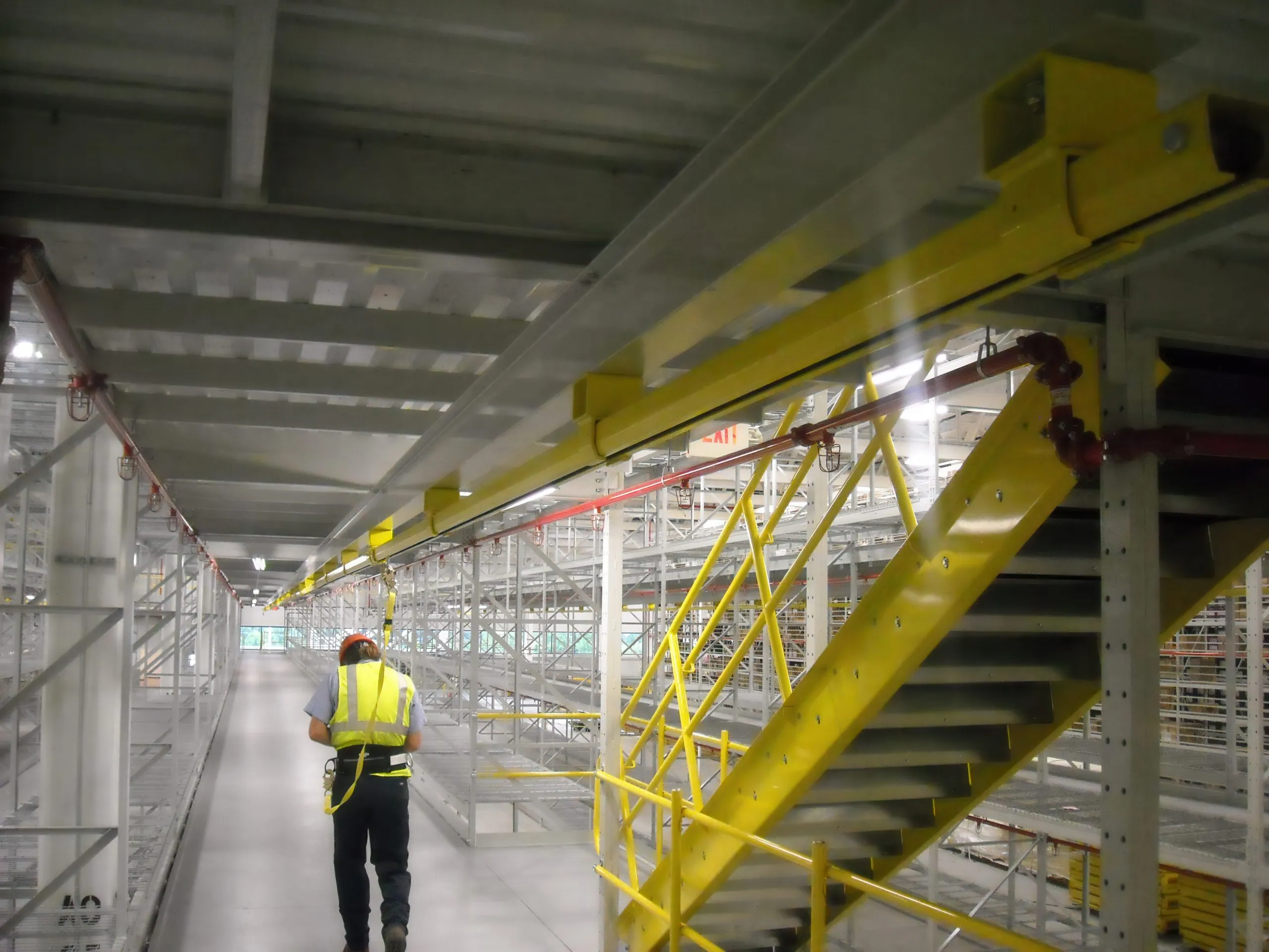 Overhead rigid rail fall protection system installed in industrial facility