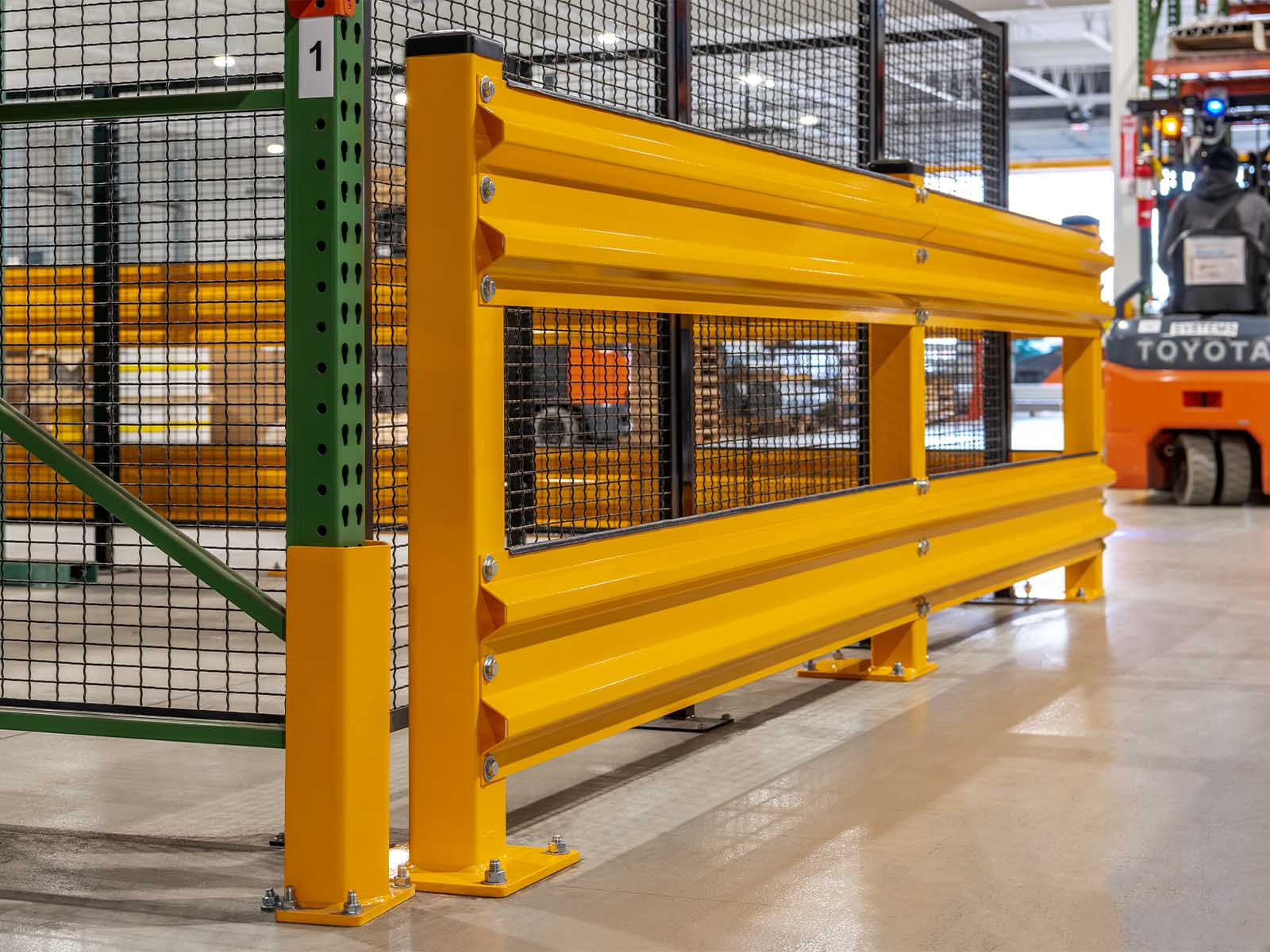 Warehouse traffic barriers installed to protect pedestrians and equipment in busy warehouse environment