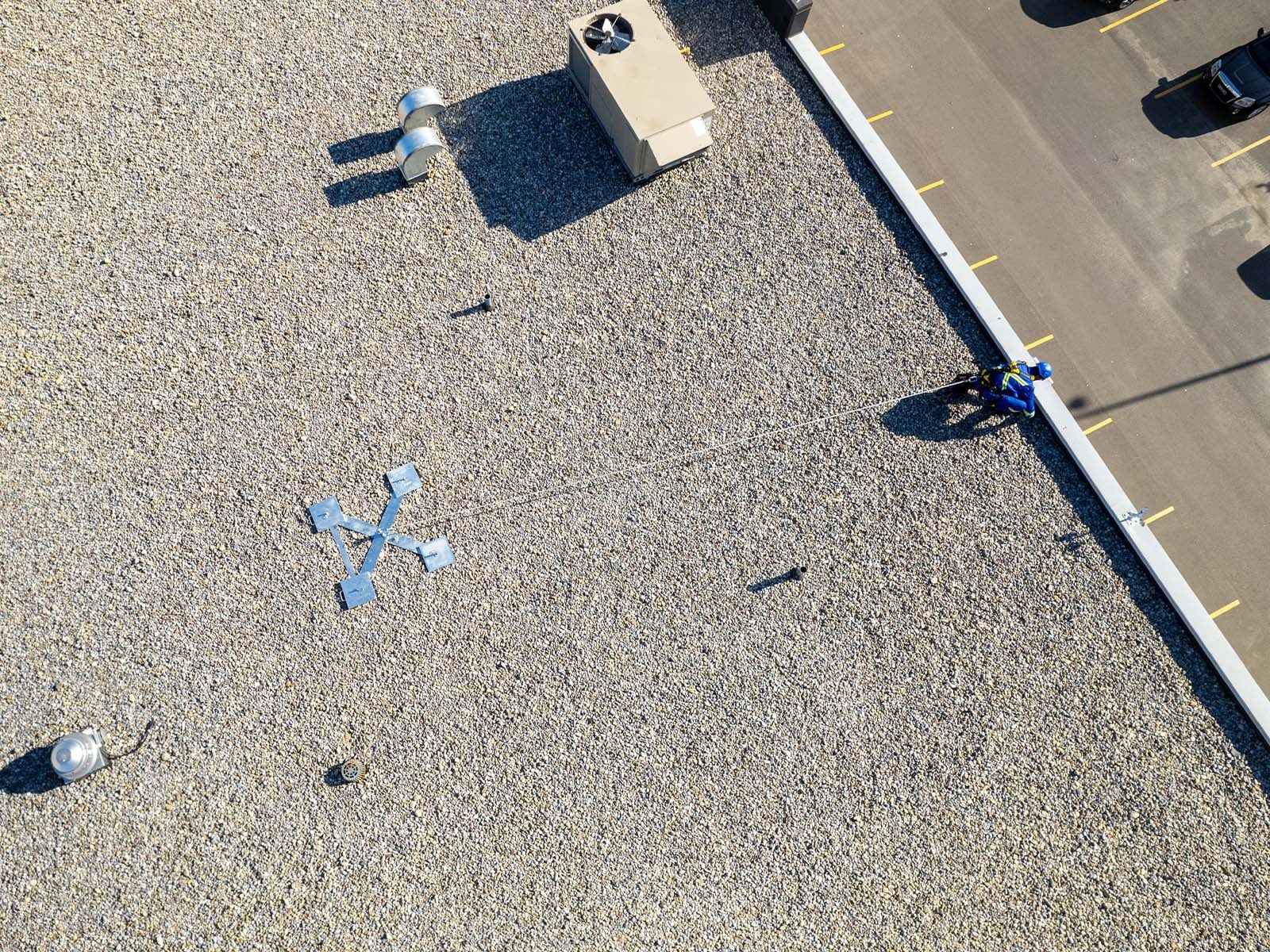 Weighted anchor system used for non-penetrating fall protection on rooftops