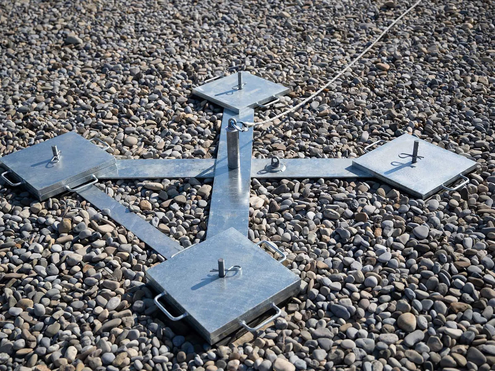 Weighted anchor system used for non-penetrating fall protection on rooftops