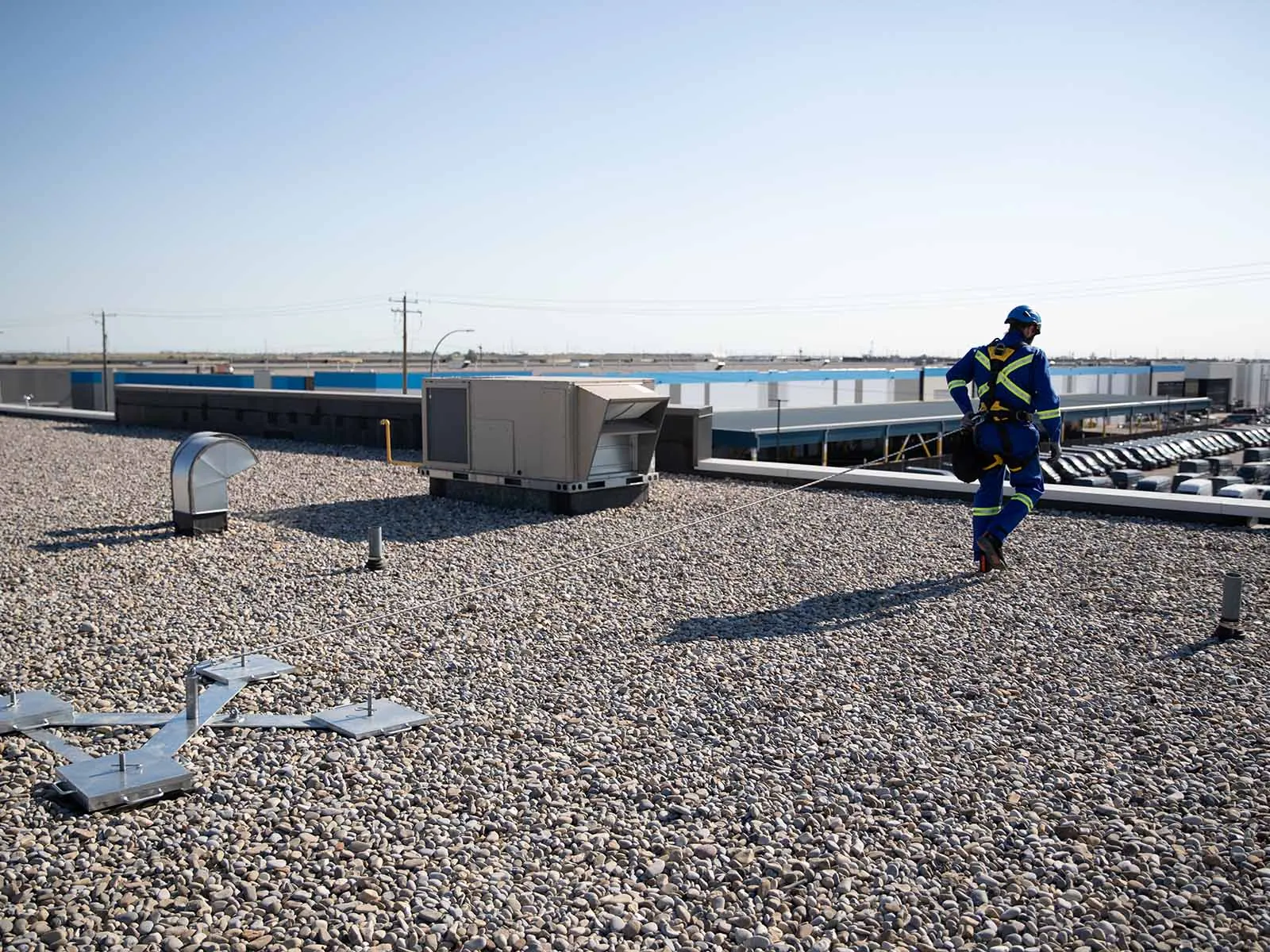 Weighted anchor system used for non-penetrating fall protection on rooftops