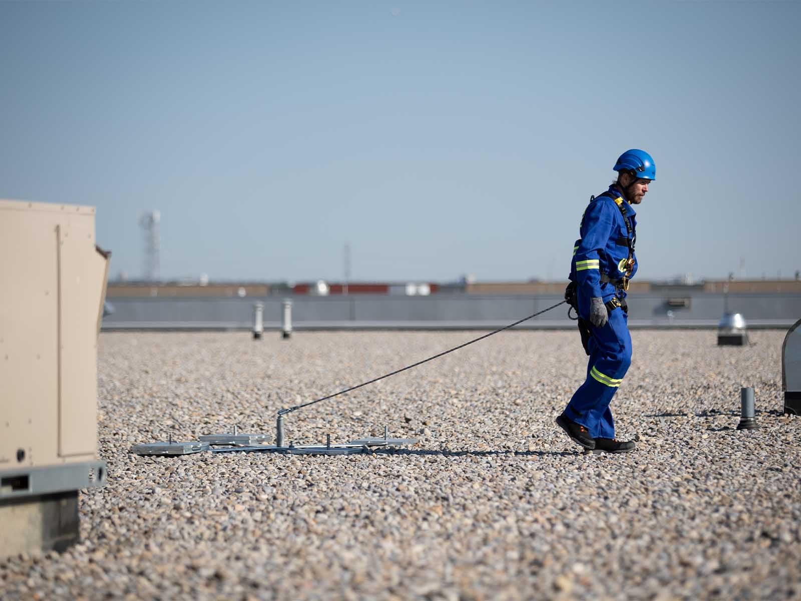 Weighted anchor system used for non-penetrating fall protection on rooftops