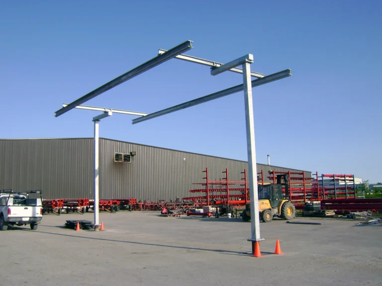 Freestanding galvanized rigid rail frame over an outdoor trailer loading area