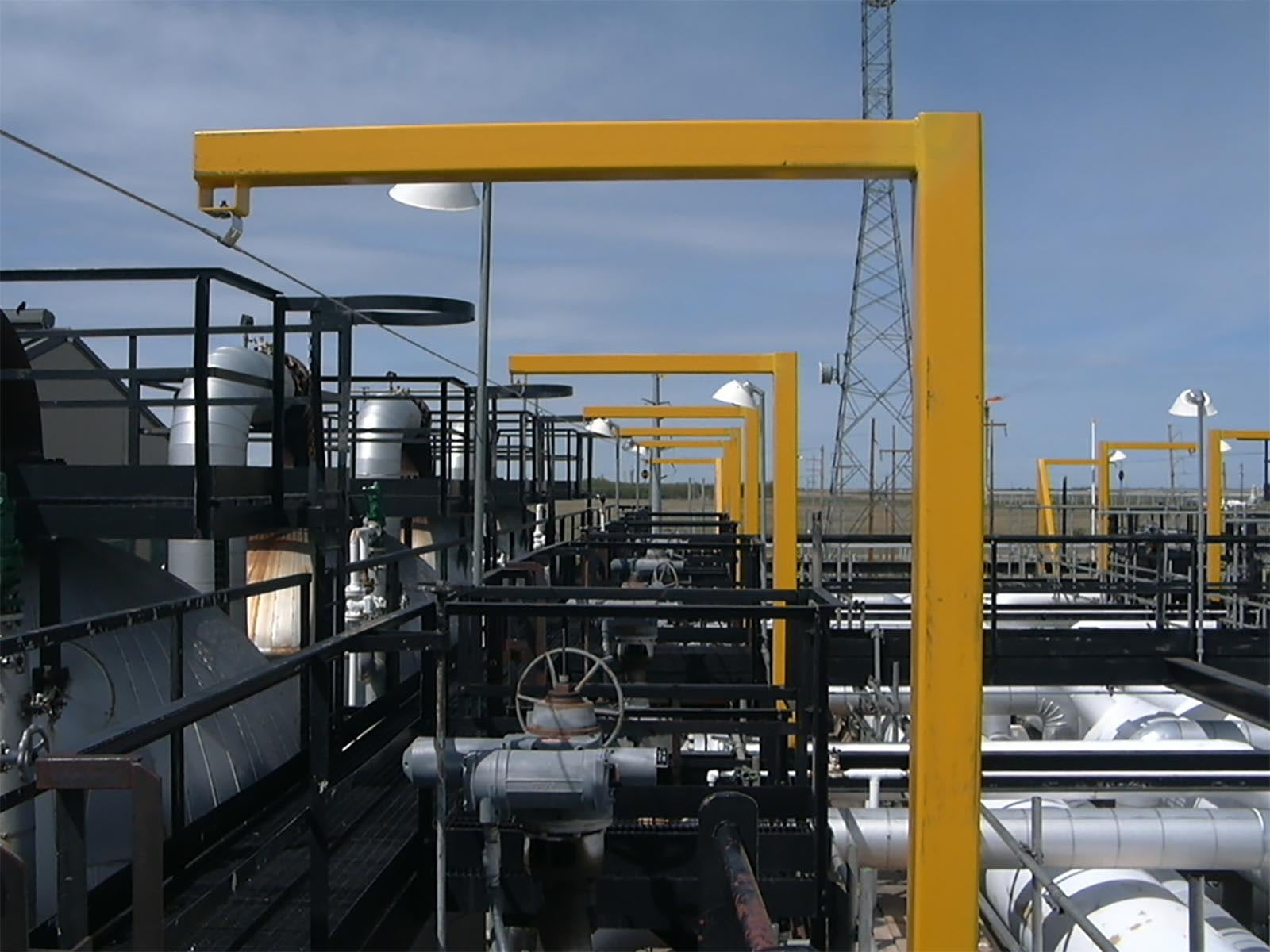 Fall protection system installed for safe access along elevated pipe rack structure