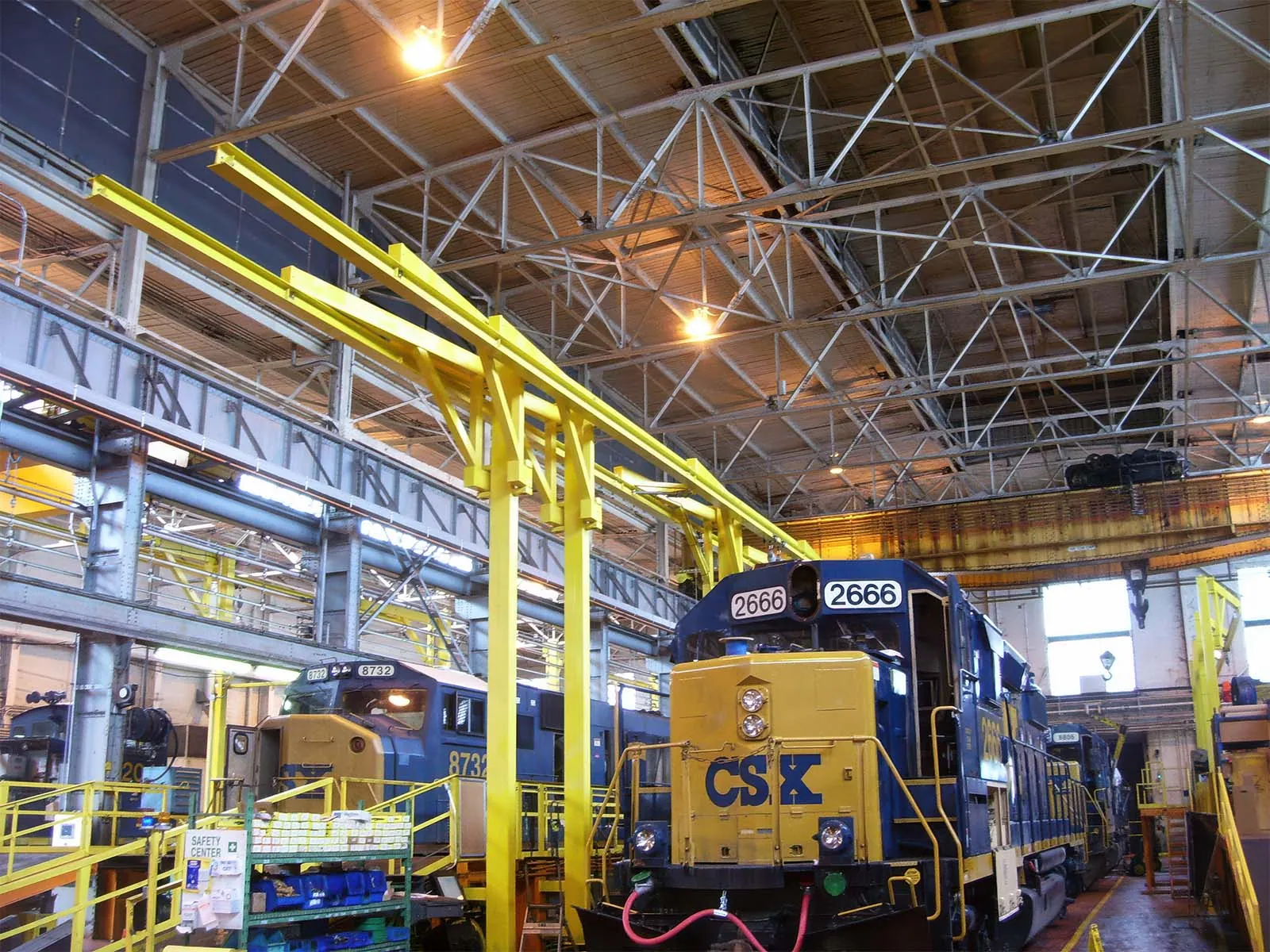 Rigid rail system installed for safe loading and unloading of railcars and transport vehicles