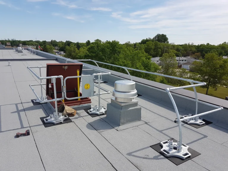 Galvanized guardrail and gate around a roof hatch on a membrane roof